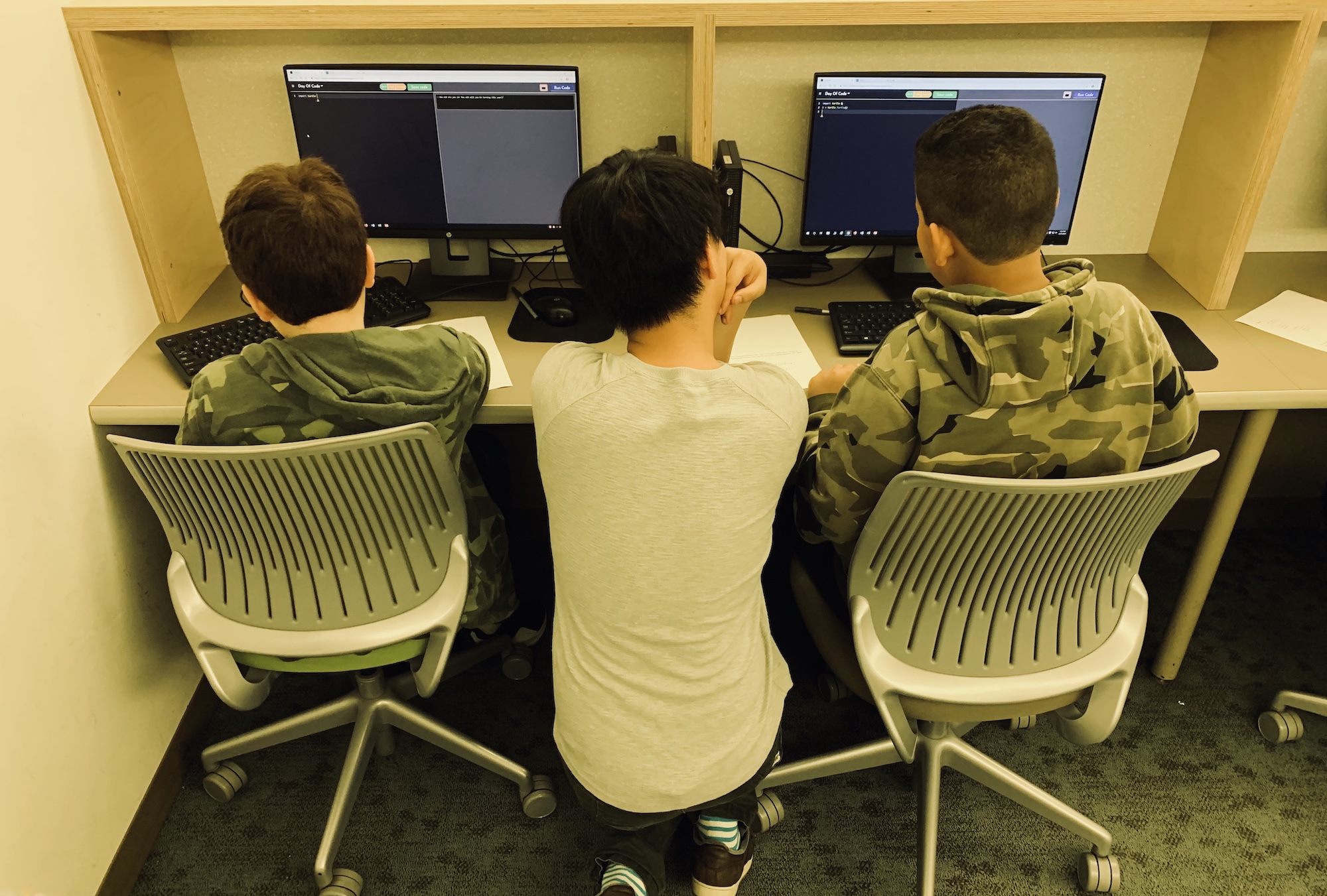 Tutors working with students at our Day of Code event